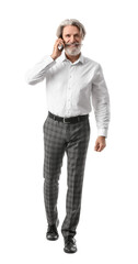 Portrait of senior businessman talking by mobile phone on white background