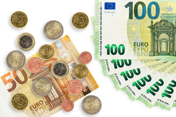 Fifty and hundred euro note with coins isolated on a white background