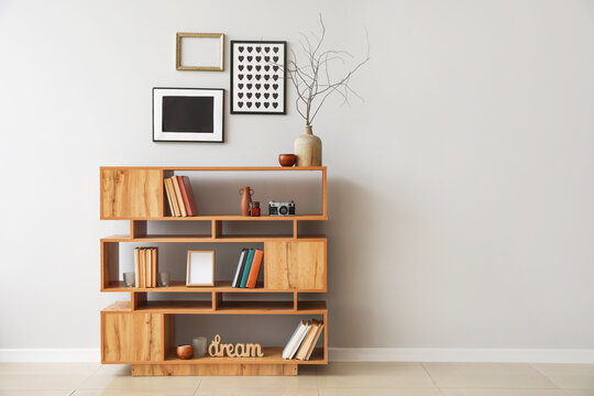 Shelving unit with books and decor in interior of room