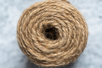High-quality handmade coil made of natural hemp rope, isolated on a white background. Rustic beige cord made of eco material