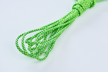 Coil of green paracord on white background