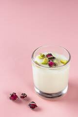 Mahalabia or malabi. Arabic milk pudding topping wit rose and pistachio.