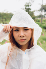 woman wear raincoat stand
