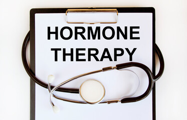 On the tablet for writing the text hormone THERAPY, next to the stethoscope.