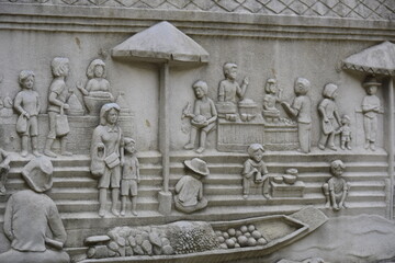 Cement sculpture tells the story of Thai people in the past.