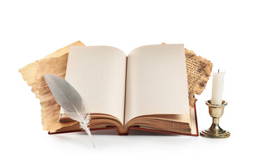 Old book with feather and candle on white background