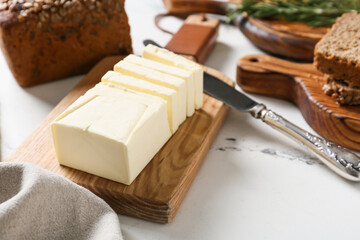 Chopping board with fresh butter on table