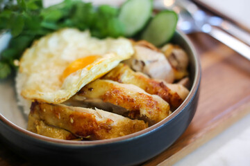 Chicken  rice with coriander and .fried egg in bowl.
