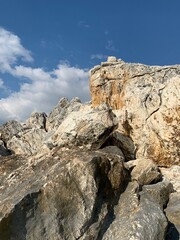 Rocky sea stones in the blue sky background, coast
