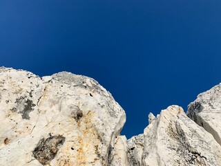 Rocky sea stones in the blue sky background, coast