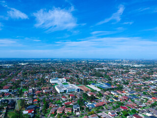 Fototapeta na wymiar Panoramic Aerial View of Sydney Western suburbs showing house roof tops roads cars and other buildings 