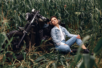 Sensitive, graceful and charming adult woman in a denim suit posing and sitting next to a huge...