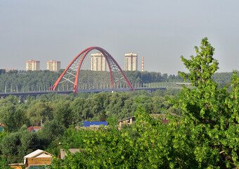 Fototapeta premium Bugrinskij bridge among green trees