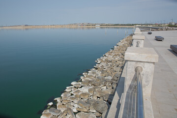 Fototapeta premium Boyukshor Lake in Baku Azerbaijan . According to geological data, the average depth of the water in the lake is 3.40-3.95 meters . An oval bridge from iron and wood on the edge of the lake .