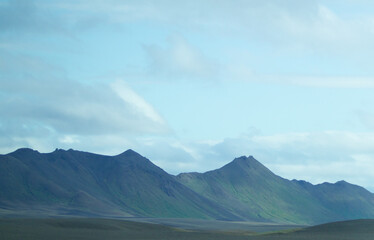The peaks of the green hills.