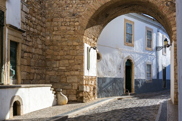 Fototapeta na wymiar Narrow winding street of the historical center of Faro, Algarve, Portugal.
