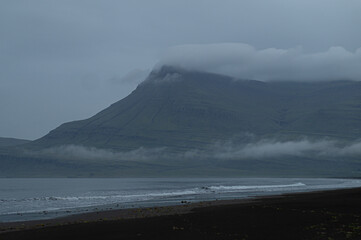 Foggy mountain and dark ocean.