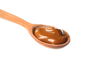 Spoon with caramel condensed milk isolated on white background