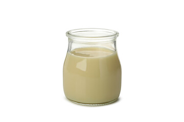 Glass jar with condensed milk isolated on white background