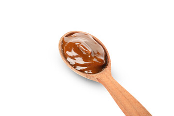 Spoon with caramel condensed milk isolated on white background