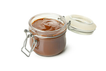 Glass jar with caramel condensed milk isolated on white background