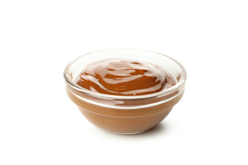 Glass bowl with caramel condensed milk isolated on white background