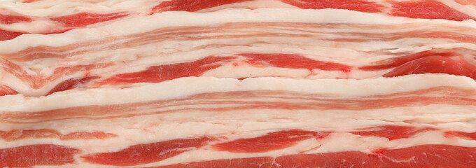 Tasty raw bacon on whole background, close up