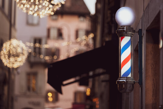 Barber shop pole and Christmas lights in Udine city, Friuli Venezia Giulia, Italy