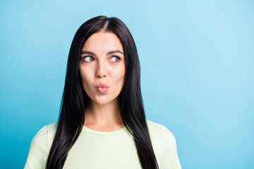 Obraz premium Photo portrait of flirty girl with plump lips looking at blank space isolated on pastel blue colored background
