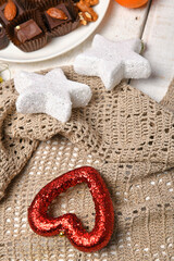 sweet food top view background for merry christmas or new year holiday decoration - chocolate candies, tangerines, cookies on white wood