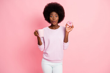 Portrait of pretty amazed funny girlish cheerful wavy-haired girl drinking latte eating tasty yummy...