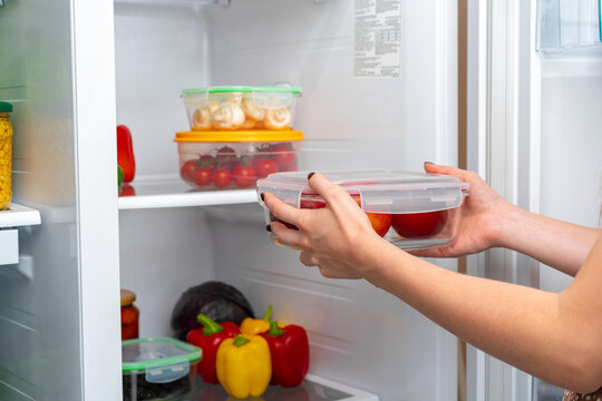 Female Hands Taking Storage Box With Food From A Fridge