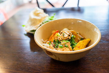 Mi Quang: is a Vietnamese noodle dish that originated from Quang Nam Province in central Vietnam. Mi quang and raw material as pork meat, salad, vegetable, chilli, lemon, yellow noodle, dried shrimp.