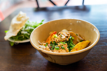 Mi Quang: is a Vietnamese noodle dish that originated from Quang Nam Province in central Vietnam. Mi quang and raw material as pork meat, salad, vegetable, chilli, lemon, yellow noodle, dried shrimp.