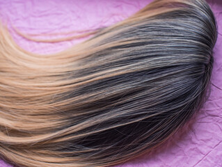 Fototapeta premium Wigs, natural and synthetic hair. Women's beauty concept. Close up photo of wig, hair for ladies