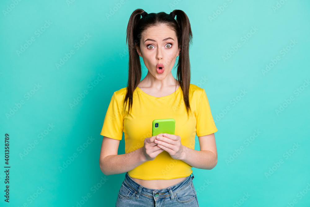 Sticker portrait of impressed brunette girl hold telephone wear t-shirt isolated on blue color background