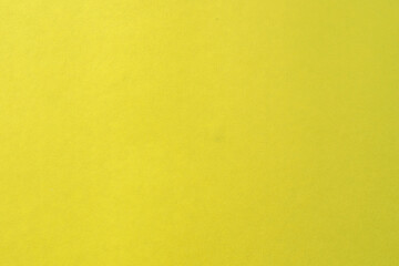 Illuminating yellow background with simple surface.