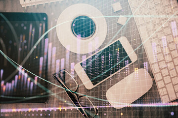 Multi exposure of forex graph hologram over desktop with phone. Top view. Mobile trade platform concept.