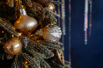 silver and gold decorations and garlands on the christmas tree