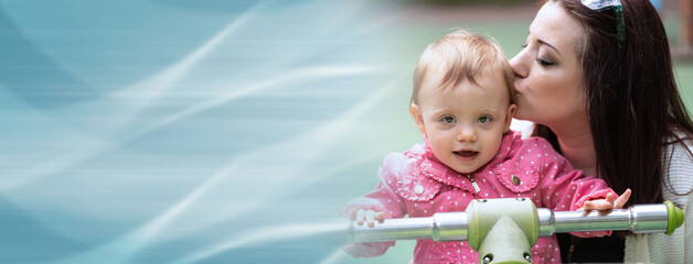 Portrait of mother kissing her baby girl; panoramic banner