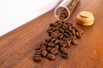 scattered coffee beans on a wooden table