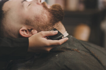 man gets a shave in the salon