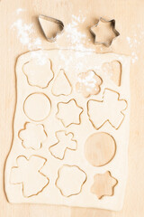 Dough for baking cookies on paper with cookie cutter molds