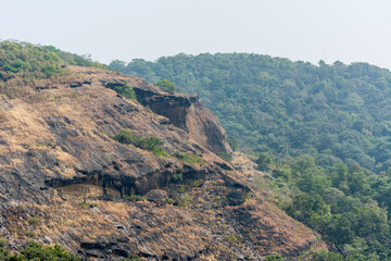 Fototapeta na wymiar Top of mountains with black rock land forms in autumn of Sanjay Gandhi National Park, Mumbai, India