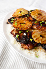 Homemade Hawaiian Huli Huli Chicken on a white plate on cloth, low angle view.