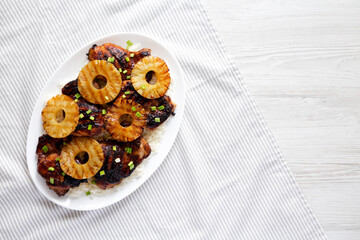 Homemade Hawaiian Huli Huli Chicken on a white plate, top view. Flat lay, overhead, from above. Space for text.