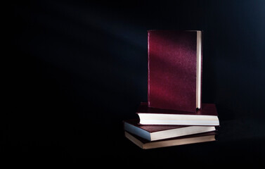 stack of old books on black background