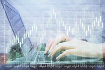 Multi exposure of woman hands typing on computer and forex chart hologram drawing. Stock market analysis concept.