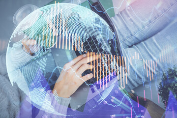 Double exposure of woman hands typing on computer and forex chart hologram drawing. Stock market invest concept.