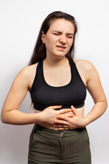 A woman's stomach hurts. Abdominal pain due to gastritis, stomach ulcers and Crohn's disease....